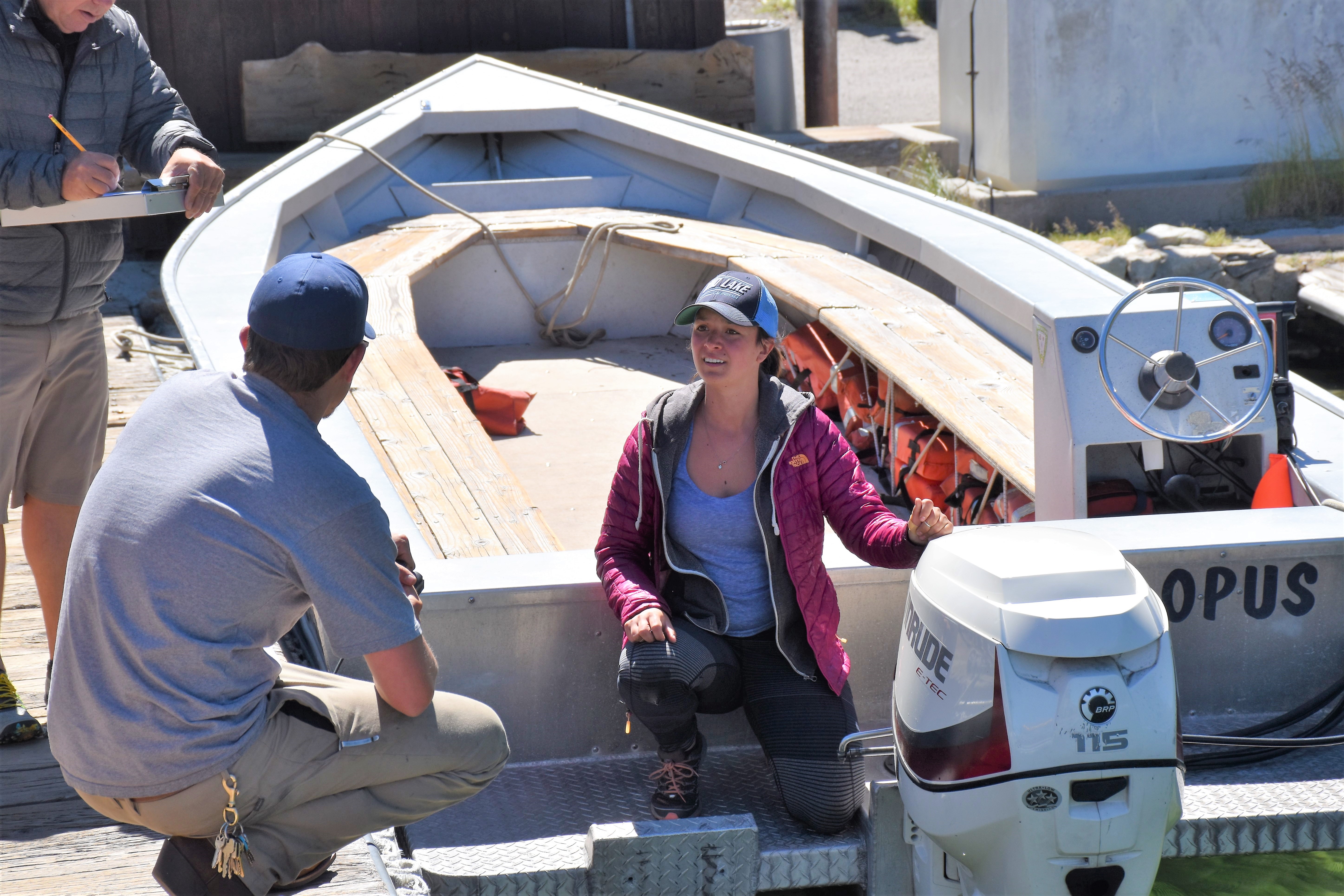 Woman boater talking to man at boat parked in dock